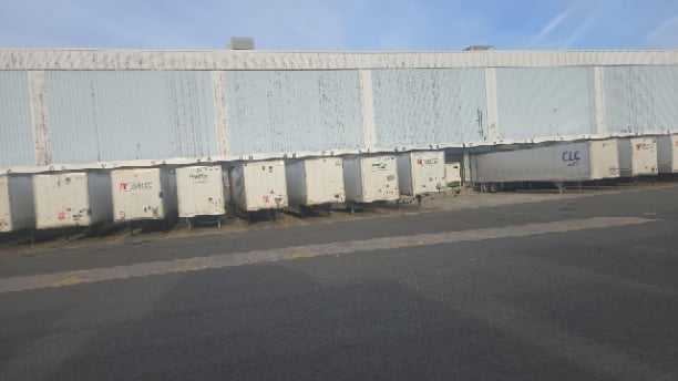 Shipping containers at warehouse facility